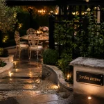 Aménagement des jardins : allée en dalles, haie taillée et coin repas sous pergola, jardin intime